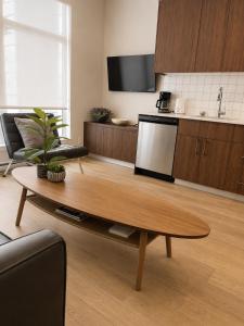 a living room with a coffee table and a kitchen at Lovely Brand New Suite in Sidney +4 photos