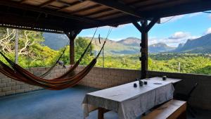 a hammock room with a view of the mountains at Kombi Hostel Camping in Vale do Capao
