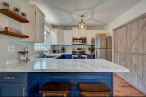 a kitchen with blue cabinets and a large counter top at Central White Mountains Retreat in Bartlett