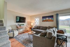 a living room with a couch and a table at Central White Mountains Retreat in Bartlett