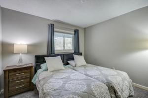 a bedroom with a large bed and a window at Central White Mountains Retreat in Bartlett