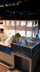 an apartment building with a swimming pool and a patio at Private Luxury Villa, River View in Shkodër