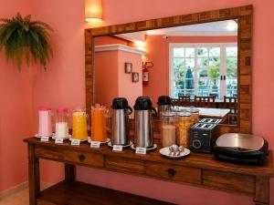 a counter with many jars of food and a mirror at Paúba Beach Hotel in Pauba