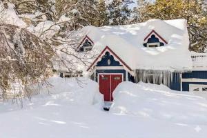 a house with a red door covered in snow at Serenity Woods - Game Room & More in South Lake Tahoe