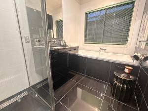 a bathroom with a shower and a sink at La Maison Barwon in Connewarre +29 photos