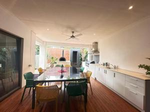a kitchen and dining room with a table and chairs at La Maison Barwon in Connewarre