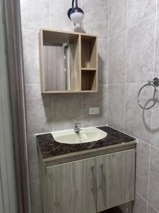 a bathroom with a sink and a mirror at Hotel San Luis in Buga +99 photos