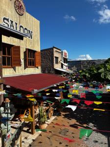 a building with a lot of flags in front of it at Pousada Vila do Cowboy in Penha