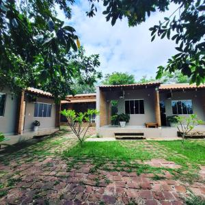 a house with a brick yard in front of it at Pousada Floradas da Serra in Chapada dos Guimarães