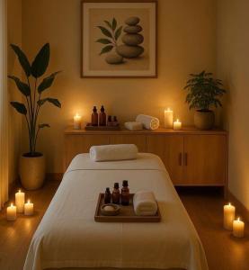 a room with a bed with candles and a tray with towels at Serenus Lounge in Senge