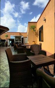 a patio with tables and chairs and a building at Serenus Lounge in Senge