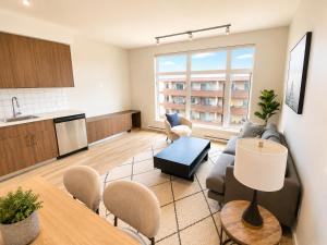 a living room with a couch and a table at Lovely Brand New Suite in Sidney +4 photos