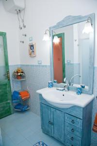 a bathroom with a blue sink and a mirror at La Casa di Baldo in Ugento +33 photos