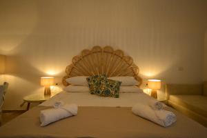 a bedroom with a large bed with towels on it at Petra Lavea in Pompei +19 photos