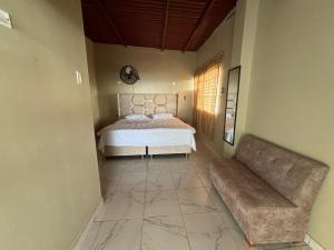 a bedroom with a bed and a couch at Amarena Resorts in Bocapán