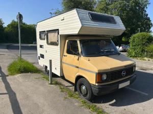 a yellow and white truck with a camper on the roof at Charmantes Oldtimer Wohnmobil in Aachen