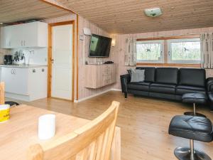 a living room with a couch and a table at 6 person holiday home in Tarm in Tarm +36 photos