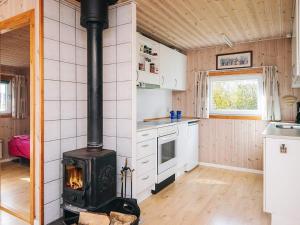 a kitchen with a stove in the middle of a room at 6 person holiday home in Tarm in Tarm
