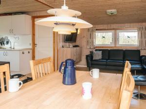 a kitchen and living room with a table and a couch at 6 person holiday home in Tarm in Tarm