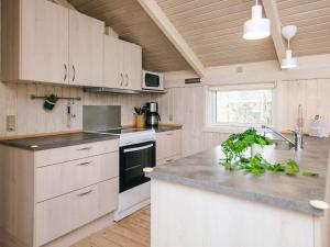 a kitchen with white cabinets and a counter top at 6 person holiday home in Ulfborg in Ulfborg