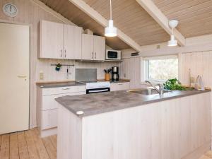 a kitchen with white cabinets and a counter top at 6 person holiday home in Ulfborg in Ulfborg