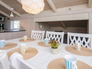 a dining room with a table with hats on it at 6 person holiday home in Ulfborg in Ulfborg