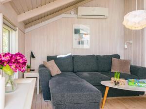 a living room with a blue couch and a table at 6 person holiday home in Ulfborg in Ulfborg
