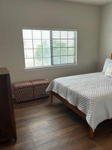 a bedroom with a bed and a large window at Boho Chic Lovely Garden Home in Spring