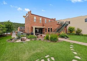 a brick house with a lawn in front of it at The Kleemann House-1883 Historic Downtown Hotel in Custer
