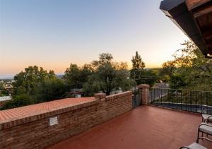 a balcony with a brick wall and a fence at LOFT Huayna picchu in La Falda