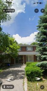 a brick house with a tree in front of it at House in Markham in Markham