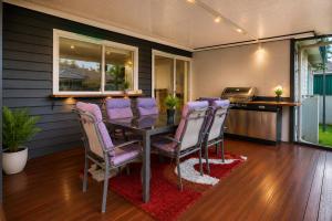 a dining room with purple chairs and a table at White House Bendigo Garden Retreat in Epsom +10 photos