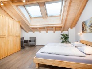 a bedroom with a bed and a vaulted ceiling at Saalbach Hinterglemm in Viehhofen