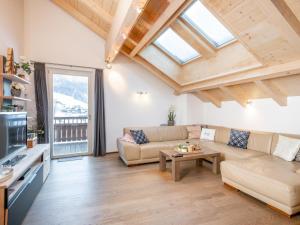 a living room with a couch and a table at Saalbach Hinterglemm in Viehhofen +15 photos