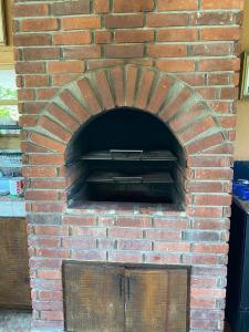 a brick oven with a door in a brick wall at Villa Ana Rosa in Jarabacoa