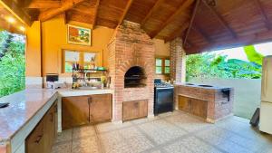 a large kitchen with a brick oven in the middle at Villa Ana Rosa in Jarabacoa