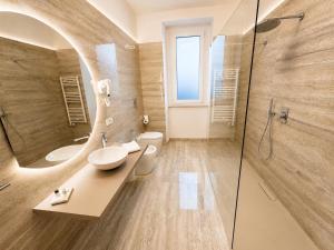a bathroom with a sink and a mirror at Valentina Rooms in Bronte