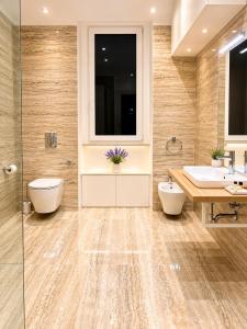 a bathroom with two sinks and a tub and a toilet at Valentina Rooms in Bronte +24 photos