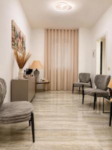 a living room with two chairs and a table at Valentina Rooms in Bronte