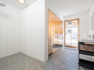 a bathroom with a shower and a sink at Haus am Bach in Donnersbachwald +21 photos