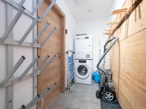 a laundry room with a washer and dryer at Haus am Bach in Donnersbachwald