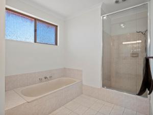a bathroom with a tub and a glass shower at Ocean Reef Marina by the Sea 4BR plus Study plus in Perth +26 photos