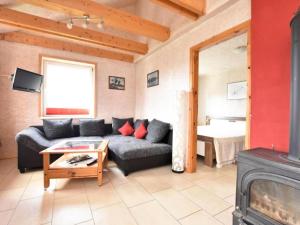 a living room with a couch and a fireplace at Am Triensee in Rühn