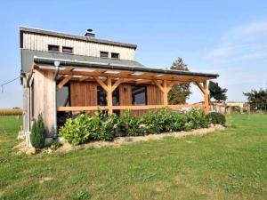 a wooden house with a solar roof on a field at Am Triensee in Rühn