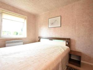 a bedroom with a bed and a window at Am Triensee in Rühn
