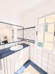 a white bathroom with a sink and a window at Casa Conduto in Ponta do Sol +27 photos