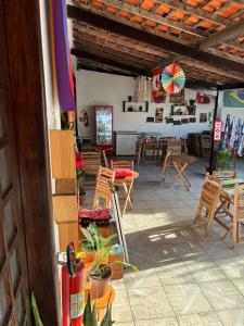 a patio with wooden chairs and tables and a restaurant at Espaço Cultural Morada in São Luís +3 photos