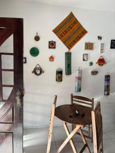 a wooden chair in front of a wall with clocks at Espaço Cultural Morada in São Luís