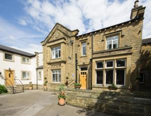 an old stone house with yellow doors at Wakefield Limes Lodge in Wakefield +13 photos