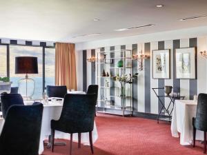 a meeting room with a long table and chairs at Hotel St Moritz, Queenstown - MGallery Collection in Queenstown